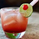 A pink cocktail in an on the rocks glass.