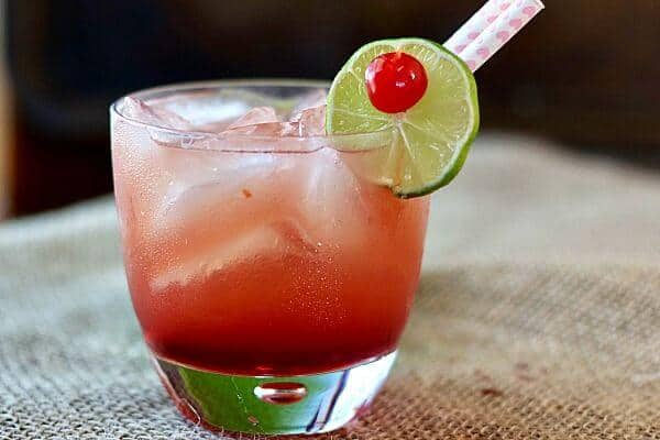 A pink cocktail in an on the rocks glass.