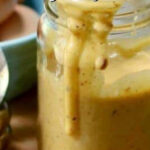 Closeup of chipotle aioli in a jar with a text overlay for Pinterest.