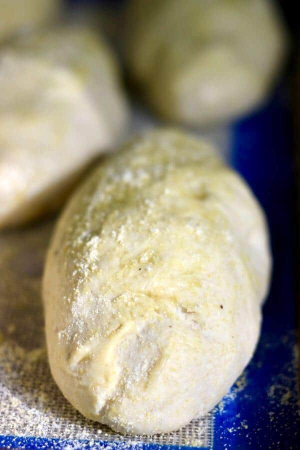Cornmeal sandwich rolls rising before baking.