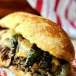 Slow cooker steak sandwiches are full of BIG Texas flavor from the cornmeal sandwich rolls to the chipotle aioli but the real star of this show is the beef! From RestlessChipotle.com