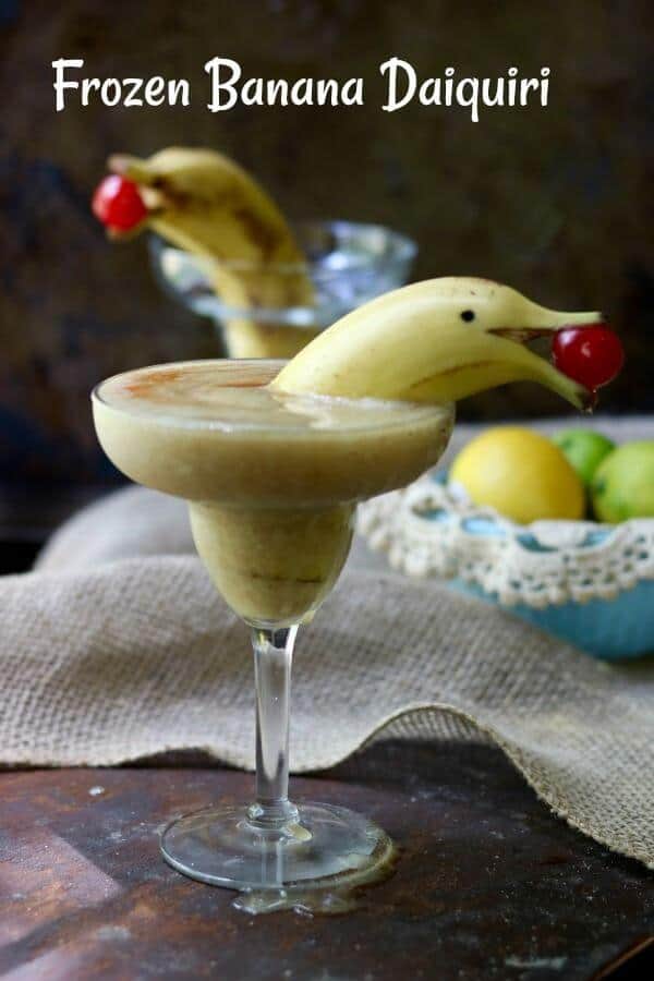 A yellow banana daiquiri with a banana cut to look like a dolphin for garnish.