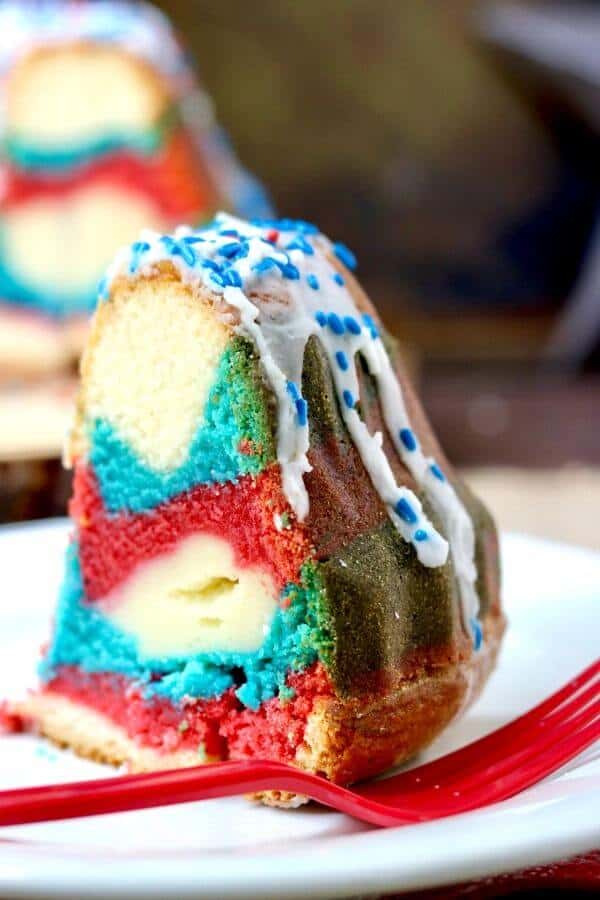 Perfect for summer holidays, this tangy red white & blue bundt cake is sweet and delicious with a tunnel of cheesecake filling right through the center. So good! From RestlessChipotle.com