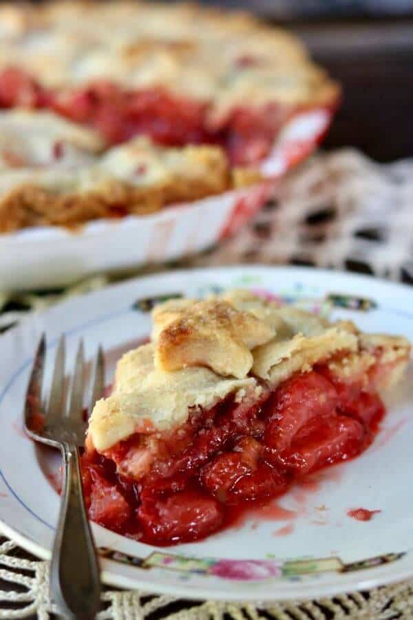 Old fashioned strawberry rhubarb pie recipe is a perfect combination of sweet and tangy with a gorgeous bright crimson filling surrounded by buttery pastry. SO YUMMY! From RestlessChipotle.com
