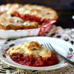 A slice of pie with on a plate with a fork.