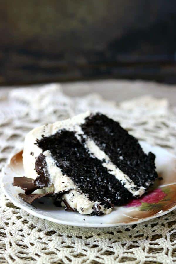 Easy dark chocolate layer cake recipe is enveloped in an airy Irish Cream buttercream frosting. SO amazing! From RestlessChipotle.com