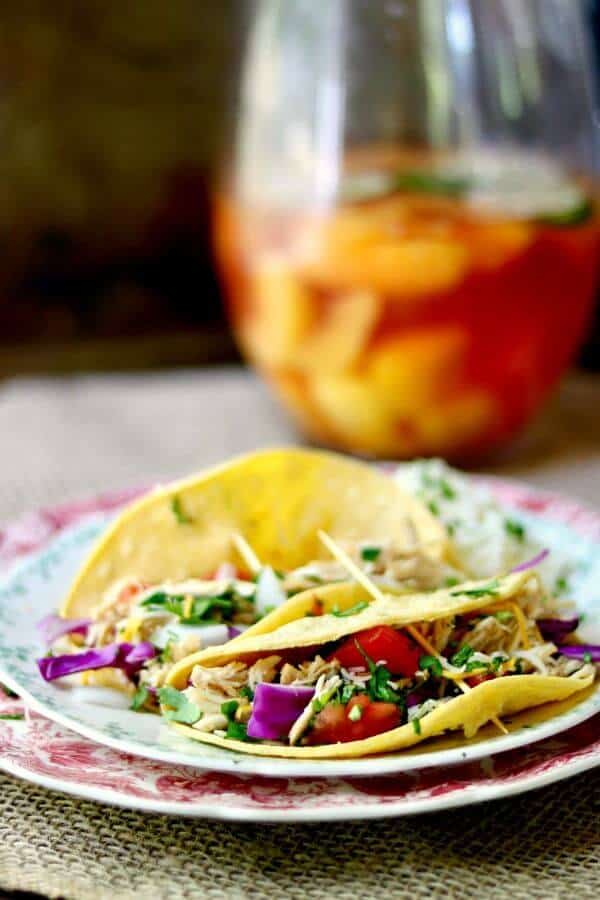 Slow cooker tequila lime chicken tacos is an easy Tex-Mex dinner recipe that cooks right in your crock pot all day long. Use chicken thighs or breast for a deliciously easy weeknight meal! From RestlessChipotle.com