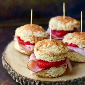 Quick and easy spiced apple and ham sliders on Cheddar cheese biscuits - just right for game day or relaxed weekend noshing. from RestlessChipotle.com