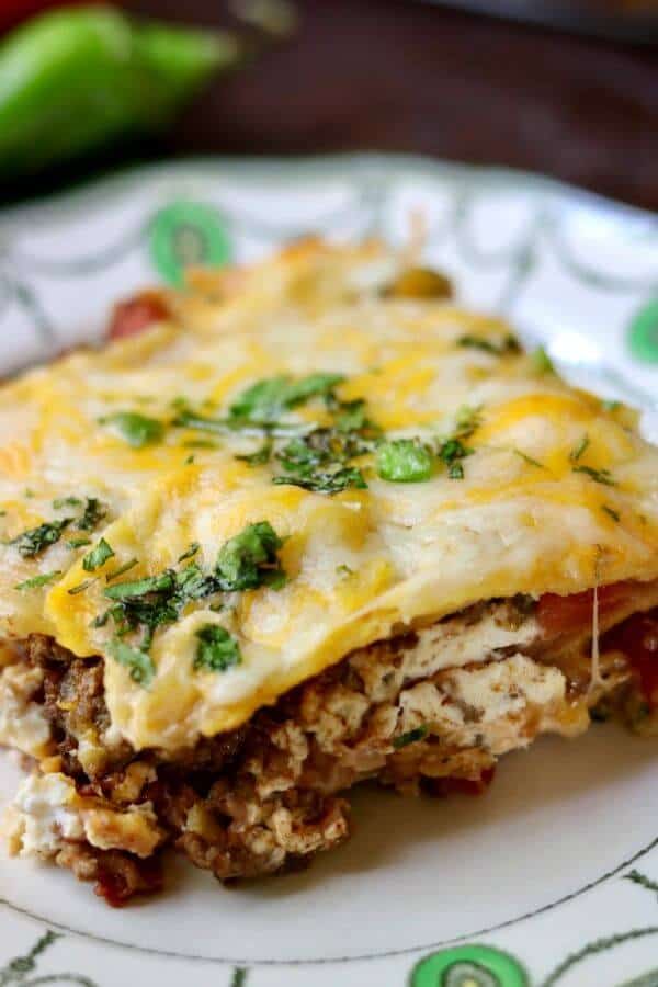 Melting cheese oozes out of this slice of easy mexican lasagna recipe made with tortillas. 