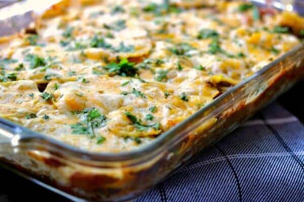 Easy casserole with a gooey, cheese topping this Mexican lasagna recipe waits to be cut and served.
