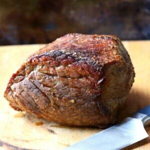 Beef round roast just out of the oven waiting to be carved