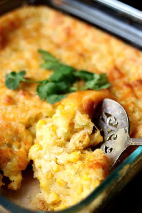 Easy Mexican corn casserole being spooned out of the casserole dish 