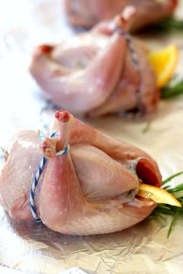 Uncooked quail is trussed for the roasted quail recipe - link to ck mondavi and family website