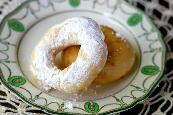 One glazed and one confectioner's sugar donut made from this homemade donut recipe