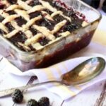 Square image of blackberry cobbler in a baking dish for the recipe template.