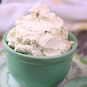 A container of homemade Cool Whip sits on a table.