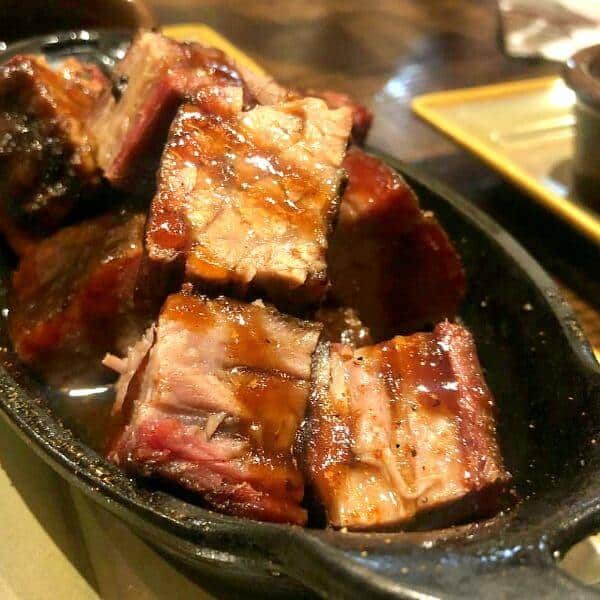 Burnt ends, a kansas city bbq delicacy, in a dish with sauce