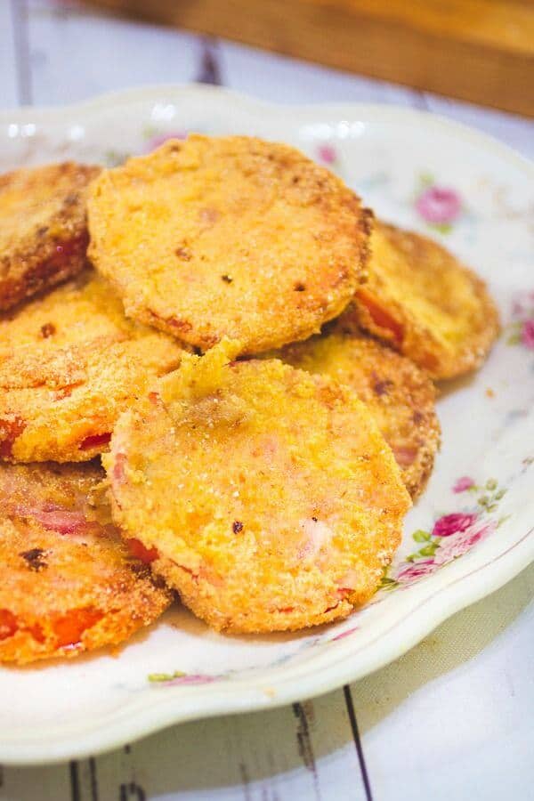 Closeup of fried green tomatoes on a vintage rose platter.