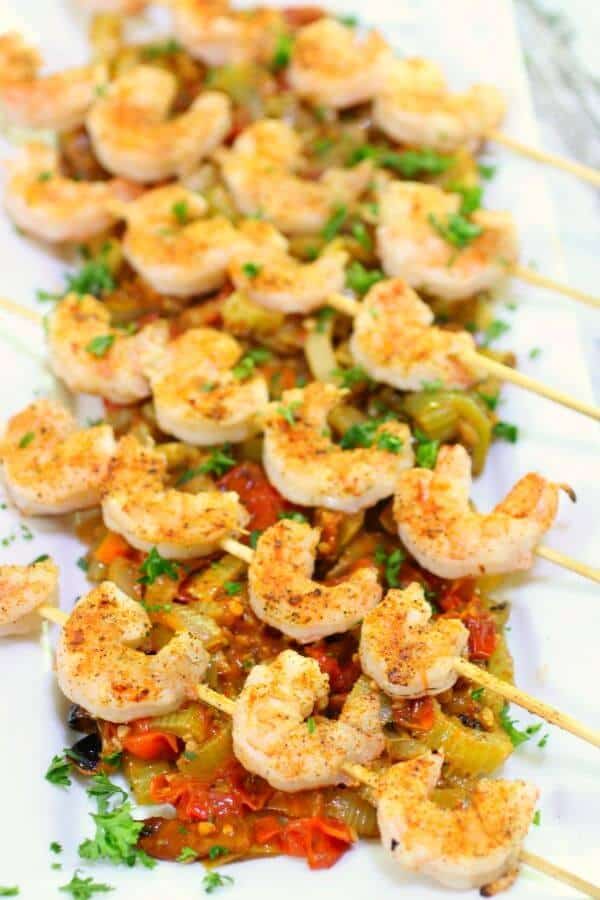 Looking down on a platter of shrimp creole on a rustic roasted tomato sauce