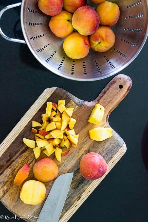 chopped peaches on a cutting board.