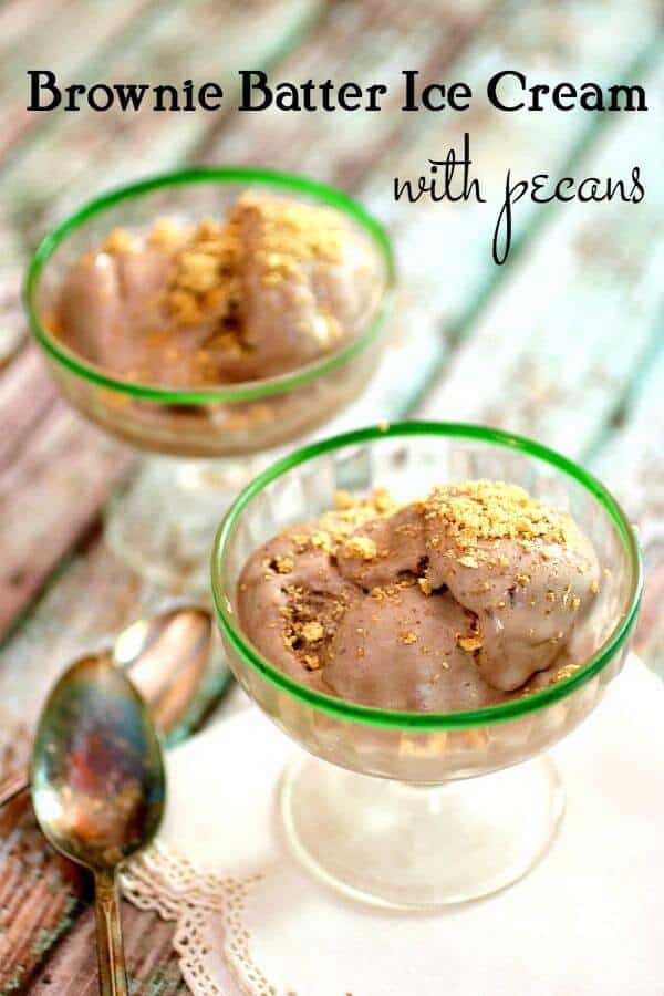 Scoops of chocolate brownie ice cream in vintage ice cream dishes with green rims. Crushed graham crackers are sprinkled on top. Title image