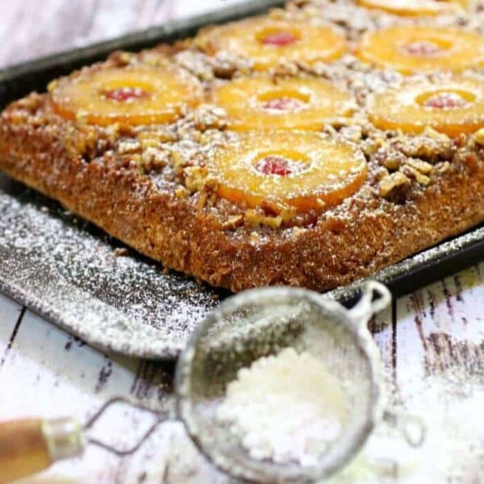 Pineapple upside down cake on a baking sheet.