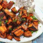 Oven roasted sweet potatoes cubed and roasted with chipotle and cinnamon. Recipe image