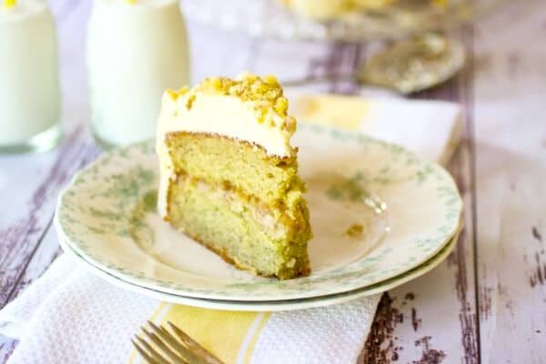 banana layer cake with walnut filling on a plate with milk in the background