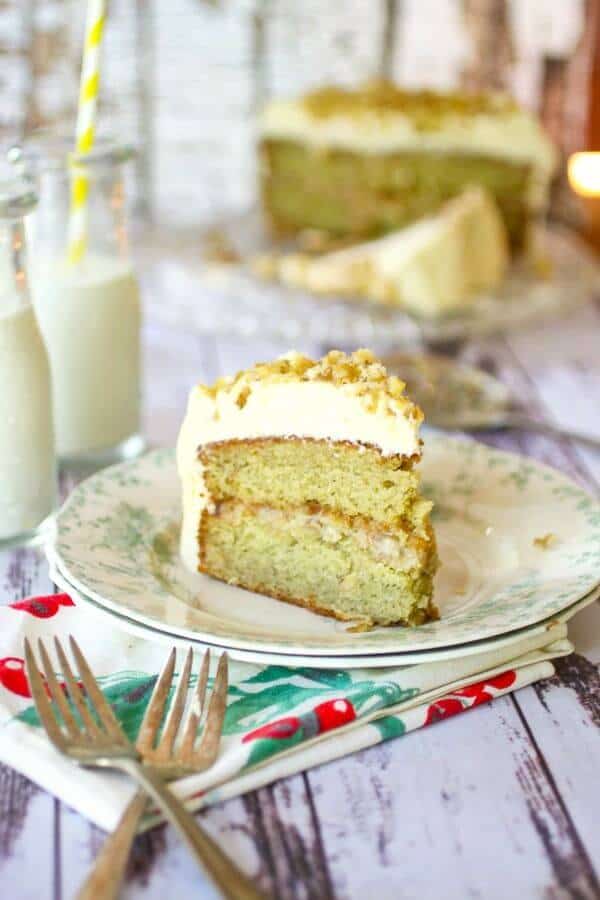 A slice of banana cake with two forks in the foreground.