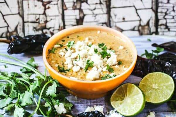 A Bowl of Soup topped with crumbled Cojita cheese