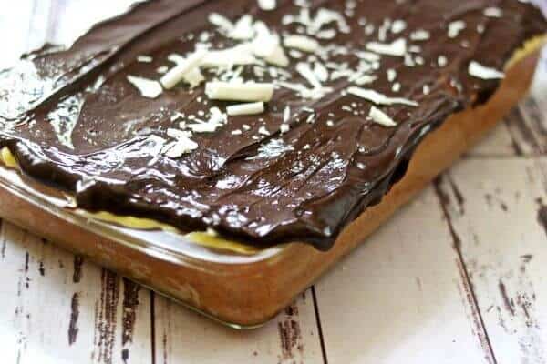A chocolate glazed cake in a glass pan