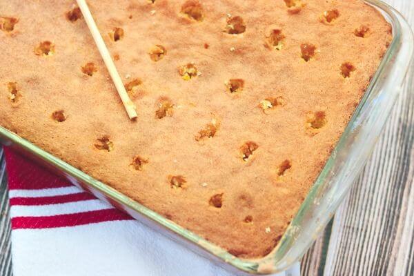 Yellow cake with holes poked in it.