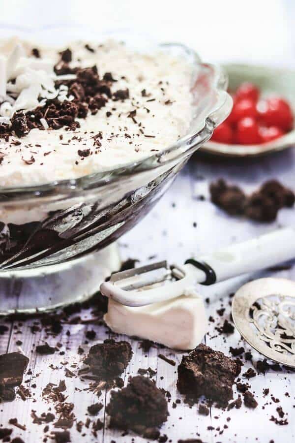 Brownie trifle with crumbled brownies on the table.