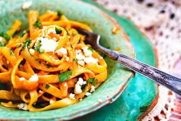 a fork in a dish of fettuccine with pumpkin Alfredo