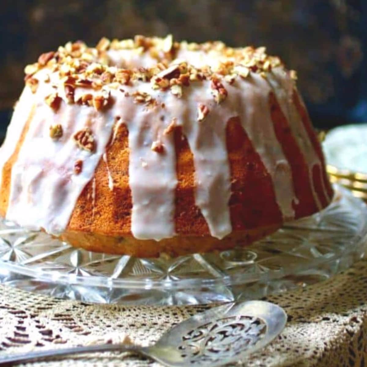 A bourbon bundt cake on a cake plate.