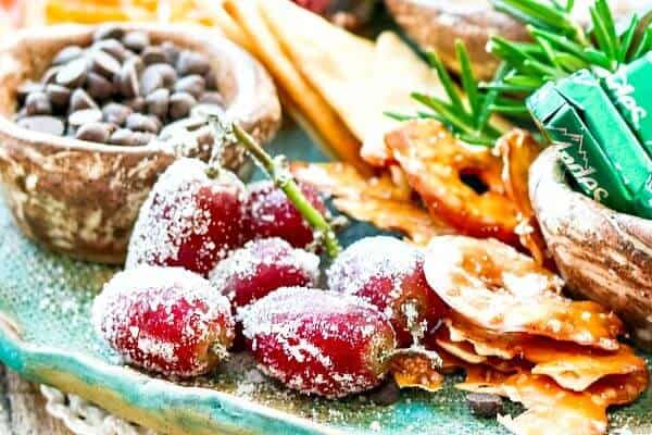 Holiday Dessert Board is a quick, easy way to create a sumptuous sweet charcuterie with something for everyone - tips and how-tos. #ideas #christmas #party Purple grapes rolled in sugar on a dessert platter