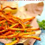 Baked sweet potato fries sprinkled with parsley on a torn brown bag. Title image.