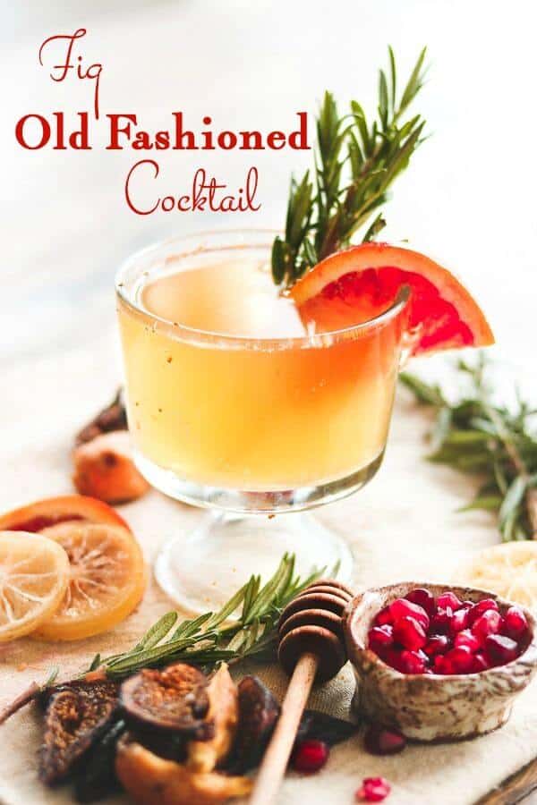 A bright bourbon cocktail with rosemary and orange garnish. Title image