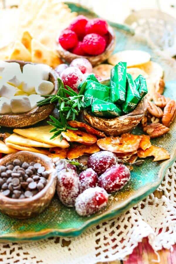 Holiday Dessert Board is a quick, easy way to create a sumptuous sweet charcuterie with something for everyone - tips and how-tos. #ideas #christmas #party Closeup of Christmas dessert platter with frosted grapes.