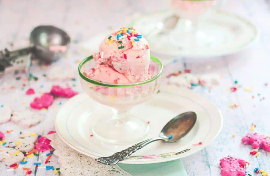 Pink ice cream in a vintage glass ice cream dish.