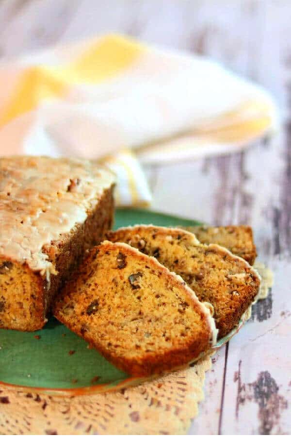 Slices of banana bread on a dark green plate.