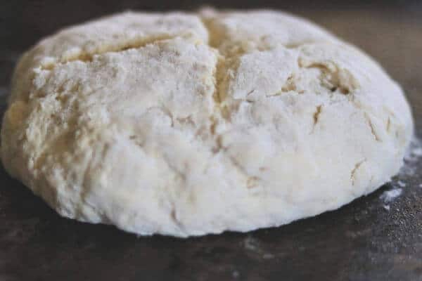 Shaping the soda bread into a round loaf.