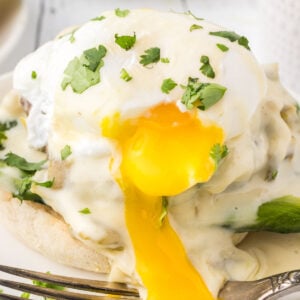 Extreme closup of the yolk flowing over the sides of the southwestern eggs benedict.