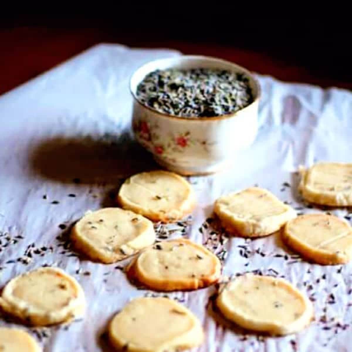 Baked cookies on a piece of parchment with dried lavender flowers.
