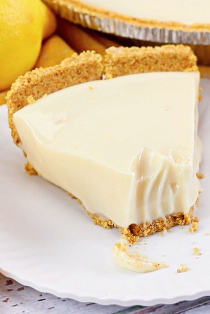 A slice of lemon pie in a graham cracker crust.