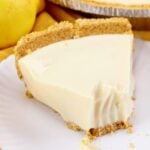 Closeup of a slice of lemon pie with a bite taken out of it for social media shares.