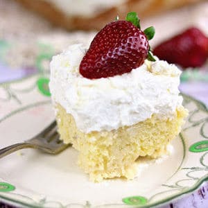 A square of tres leches cake with strawberries