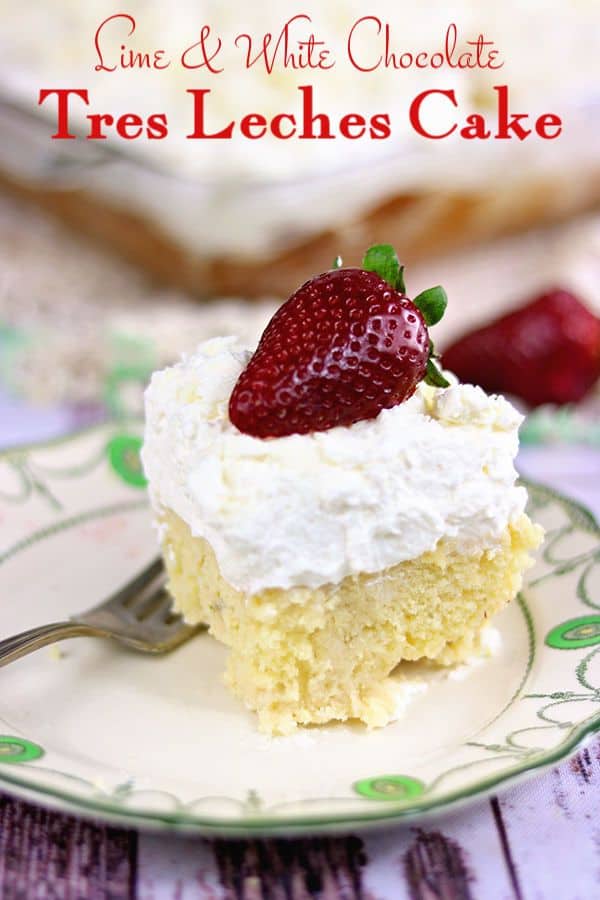 A serving of tres leches cake with thick whipped cream topping on a plate.