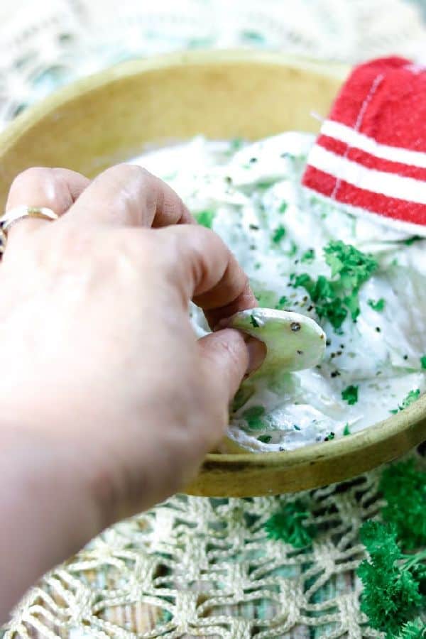 Decorative image - Fingers sneaking a cucumber from the dish.