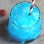 blue cocktail with a red and white straw.